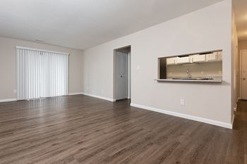 Peek Through Window From Kitchen Into the Living and Dining Room Area